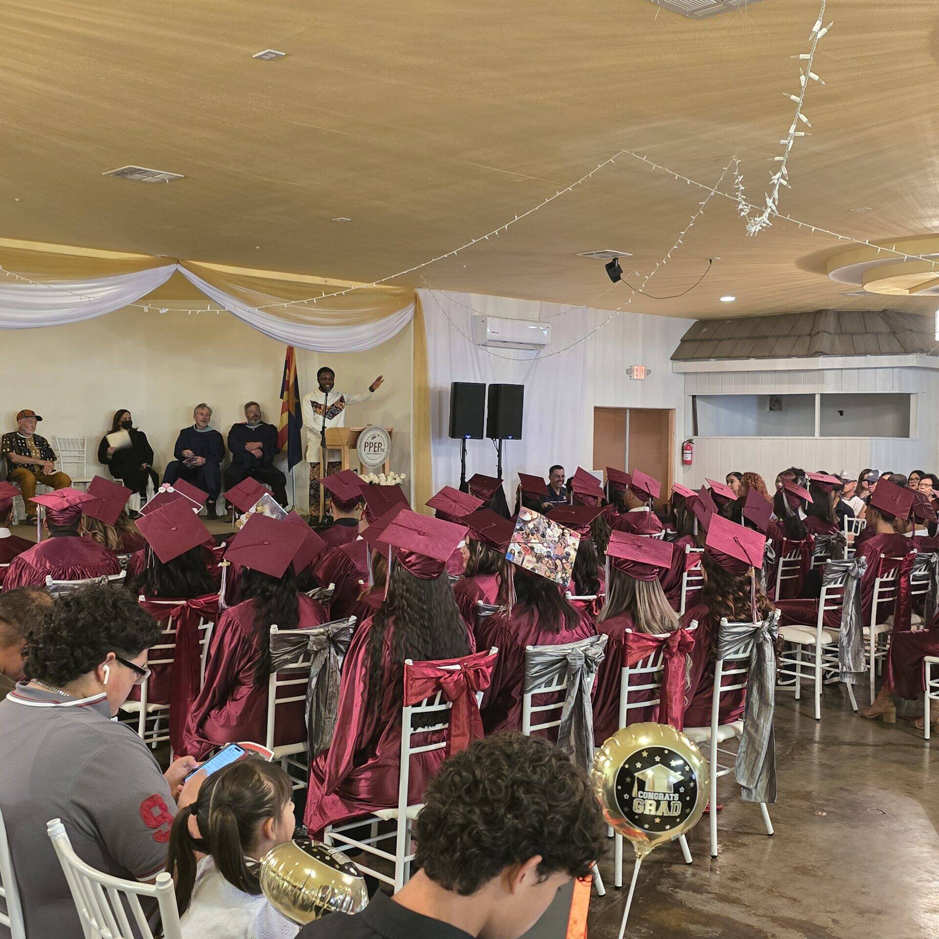 Dr. Emma giving a speech at the PPE graduation ceremony.